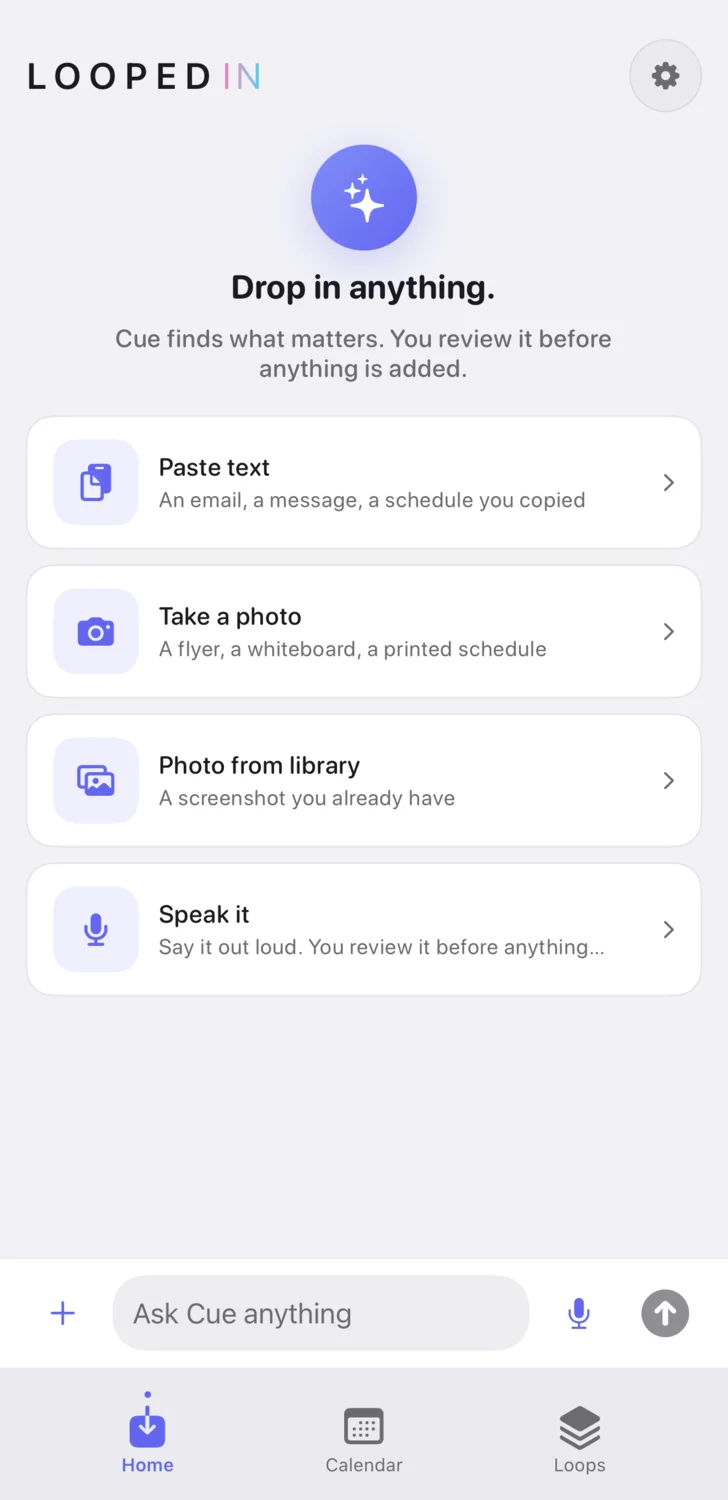 The Looped In home screen reading Drop in anything, with rows for pasting text, taking a photo, picking one from your library, and speaking it out loud, above the Ask Cue bar.